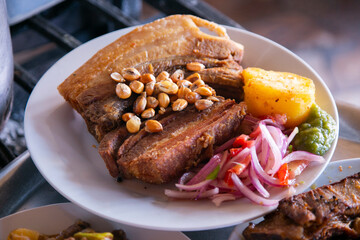 Pork chicharrón is a traditional food in Peru. Pork fat is used to cook the meat and consists of frying the skin of the pig with or without meat.