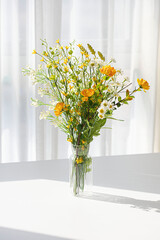 A small flower bouquet in a transparent vase