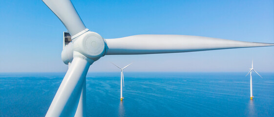Windmill Park with a blue sky close up of windmill turbines at sea