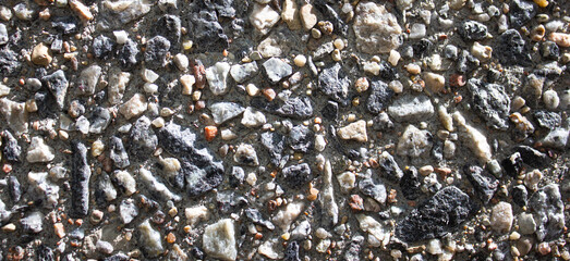 Colored pebbles, pebbles in concrete. Small authentic real pebbles in a concrete structure.