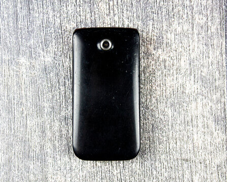 Classic mobile phone, flip.Retro folding cell phone. Old-fashioned push-button mobile wireless phone vintage.Folding phone with buttons. Old, dilapidated used phone, 2005-2010s.