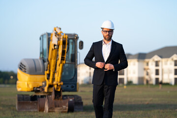 Construction manager in suit and helmet at a construction site. Construction manager worker or...