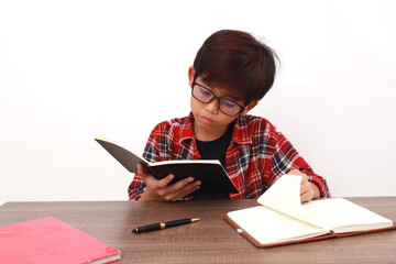 Asian student studying seriously. Isolated on white background