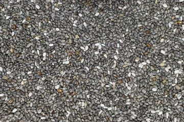 Chia seeds in wooden spoon. Healthy superfood rich in Omega 3 fatty acids. Dry healthy natural ingredient. Chia grains are falling