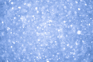 Abstract Blue Christmas Background with Real Snow. Blurred Snowflakes Photo.