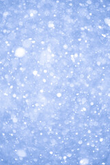Abstract Blue Christmas Background with Real Snow. Blurred Snowflakes Photo.