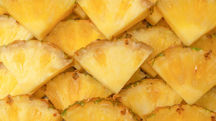 Pineapple juicy yellow slices as a background.