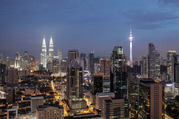 Fototapeta premium Night shot of Kuala. Panorama with city architecture and transport. Malaysia capital view with Petronas Towers and Menara Tower
