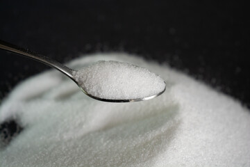 Pour the natural sweetener stevia from the packet into a spoon.