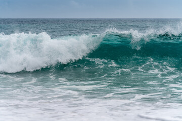 Clearest blue wavy sea on the coast of Costa Brava in spring. The sea wave is about to crash. Eco and clean nature concept.	