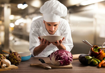 Chef smelling the aroma of a dish at the restaurant kitchen