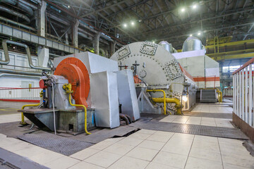 Closeup view of steam turbine and power generator.