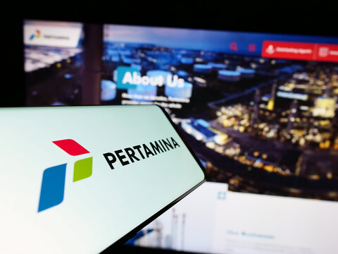 Stuttgart, Germany - 06-30-2023: Mobile phone with logo of Indonesian company PT Pertamina (Persero) on screen in front of website. Focus on center-right of phone display.