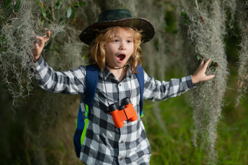 Child with backpack, traveller or explorer. Concept of exploration and discovery. Kid travel on nature outdoors, adventure and tourism, leisure trips. Travel and adventure vacation.