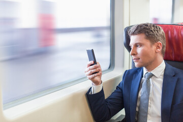 Fototapeta premium Business people with phone in a train