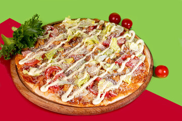 Pizza with bacon cheese and herbs on a wooden plate with cheese and cherry tomatoes. On a colored