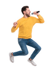 Fototapeta na wymiar Handsome man with microphone singing and jumping on white background