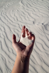 Hand holding sand in White Sands in USA