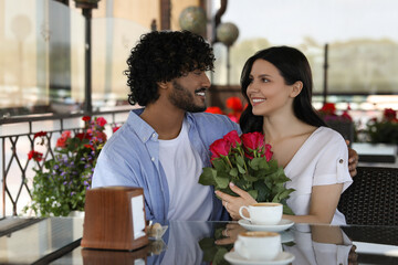 International dating. Happy couple spending time together in restaurant