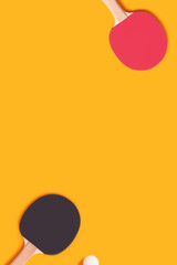 Tennis rackets and white ball on a yellow background. Ping pong composition with copy space.