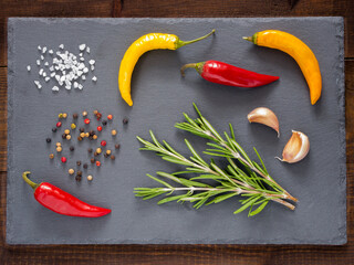Herbs and spices over slate background. Top view or flat lay. Food background