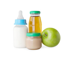 Healthy baby food, bottles with milk, juice and apple on light grey background