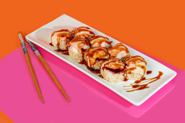 Sushi sets, rolls with caviar, shrimp, tuna and avocado and Philadelphia cheese, on a white plate.