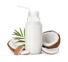 Glass bottle of delicious vegan milk, coconut pieces and green leaf on white background