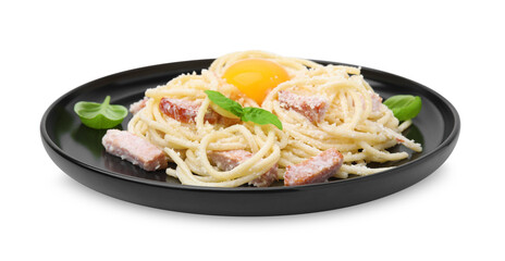 Plate of tasty pasta Carbonara with basil leaves and egg yolk isolated on white