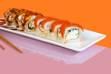 Sushi sets, rolls with caviar, shrimp, tuna and avocado and Philadelphia cheese, on a white plate.