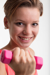 young woman weightlifting to train her body daily after running to complete her fitness workout