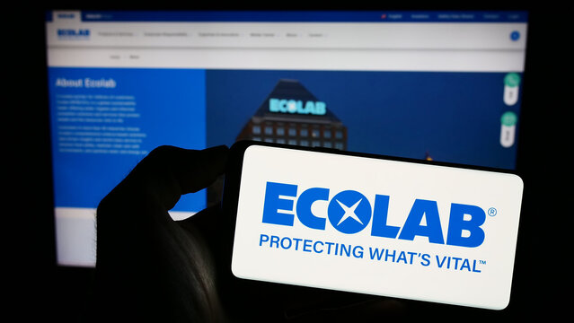 Stuttgart, Germany - 07-01-2023: Person holding mobile phone with logo of American water technology company Ecolab Inc. on screen in front of web page. Focus on phone display.