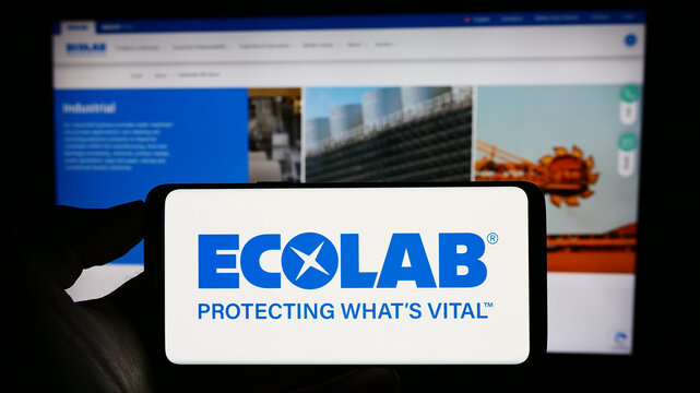 Stuttgart, Germany - 07-01-2023: Person holding cellphone with logo of US water technology company Ecolab Inc. on screen in front of business webpage. Focus on phone display.