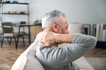 Fotobehang Massagesalon Elderly man rubbing hard pain in neck and massaging tense muscles