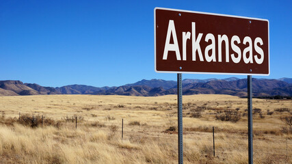 Arkansas road sign with blue sky and wilderness © Designpics