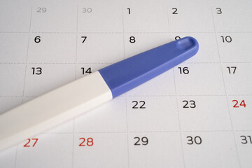 Pregnancy test on calendar, contraception health and medicine.