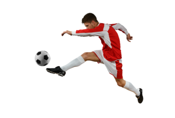 Soccer  player kicks the soccerball in the air by jumping