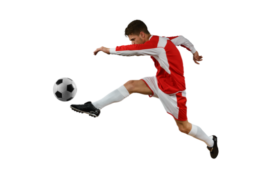 Soccer  player kicks the soccerball in the air by jumping