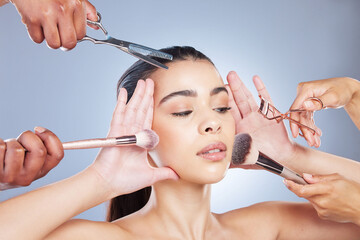 Salon, makeup and face of woman with brush in studio for wellness, beauty and cosmetics on blue...