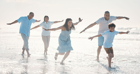 Travel, beach and happy family running together at the sea or ocean bonding for love, care and...