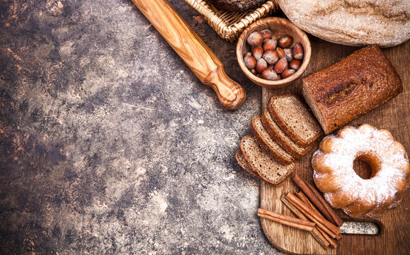Fresh bread still life bakery product top view flour egg plunger on grunge textured background