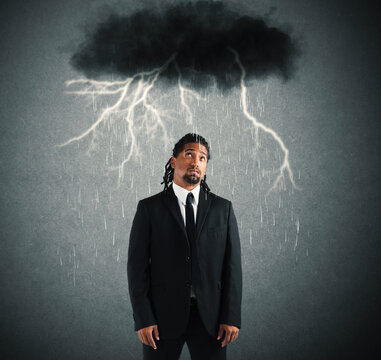 Desperate businessman with cloud over his head
