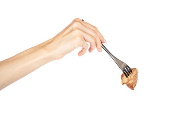Grilled meat in female hand on fork isolated on white background.
