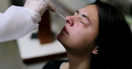 Woman having COVID nose test PCR procedure