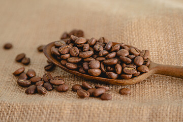 close up of Coffee beans on a wooden spoon