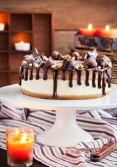 Delicious two-ply chocolate cheesecake decorated with candies and frosting