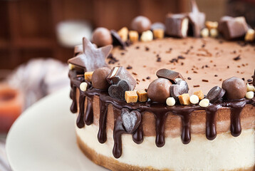 Delicious two-ply chocolate cheesecake decorated with candies and frosting