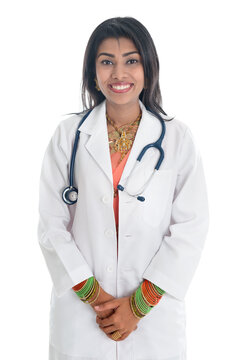 Portrait of Indian female medical doctor in uniform standing isolated on white background.