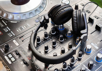 Headphones on dj console deck Big dj headphones to mix music at night club party Professional...