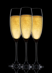 Glasses of sparkling champagne with bubbles  on black background